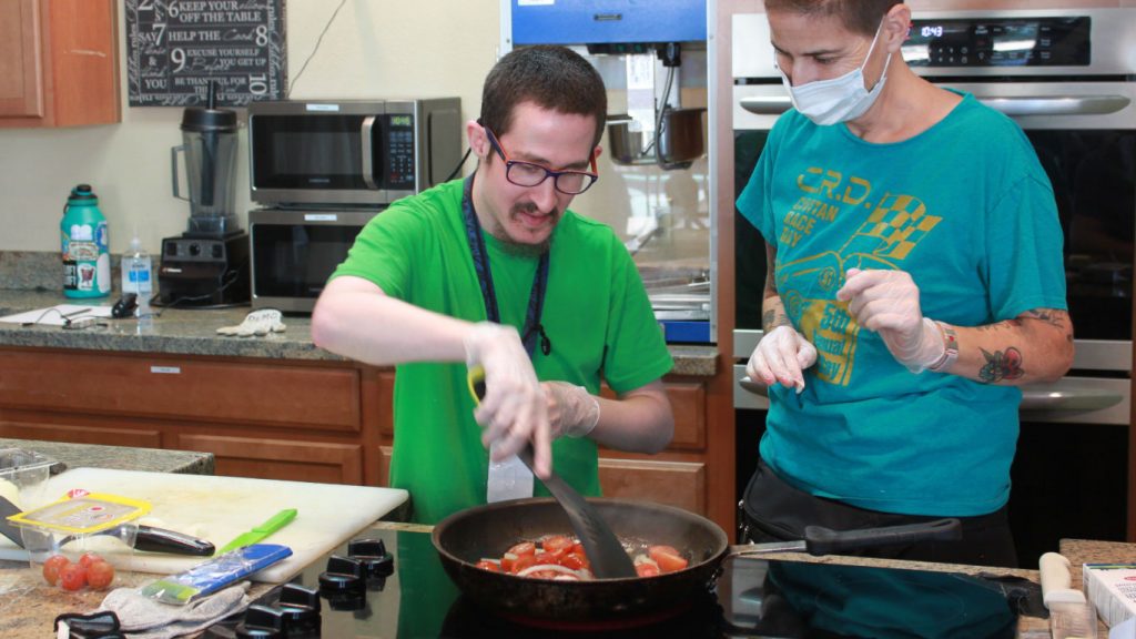 member learns how to cook tomatoes in culinary class at Civitan